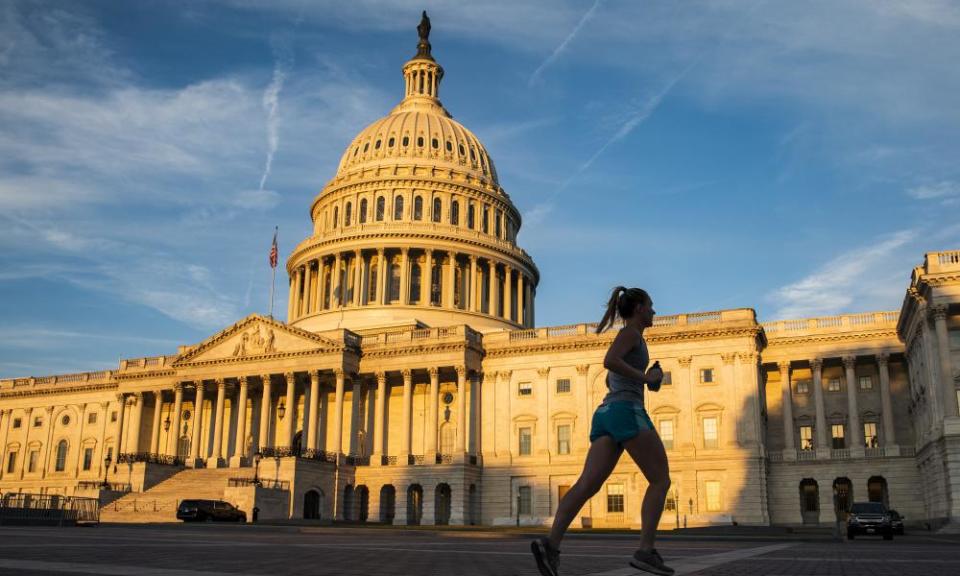 The rising sun illuminates the US Capitol Building in Washington.