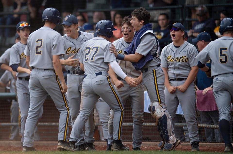 Castle celebrates Castle's Kris Butler (18) 2 RBI double against North during their sectional semifinal game at Bosse Field Saturday morning, May 28, 2022.