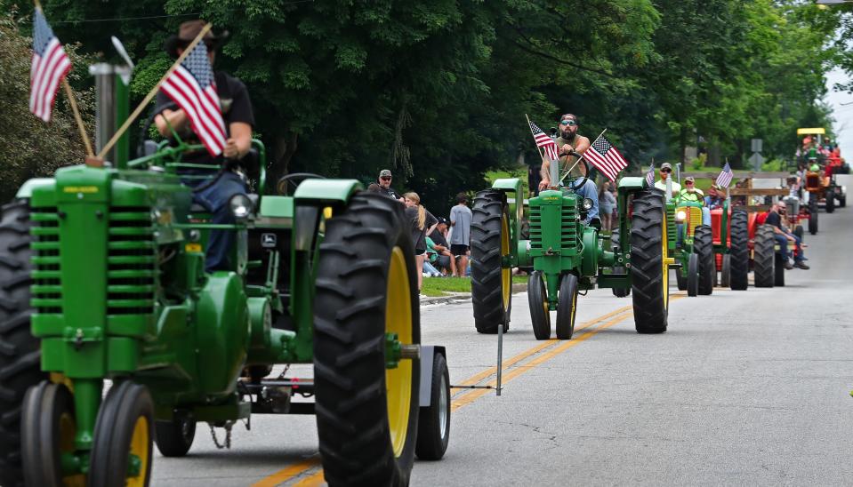 Farmers and collectors alike show off their vintage tractors during the Garrettsville Tractor Parade, Saturday, June 29, 2024, in Garrettsville, Ohio.