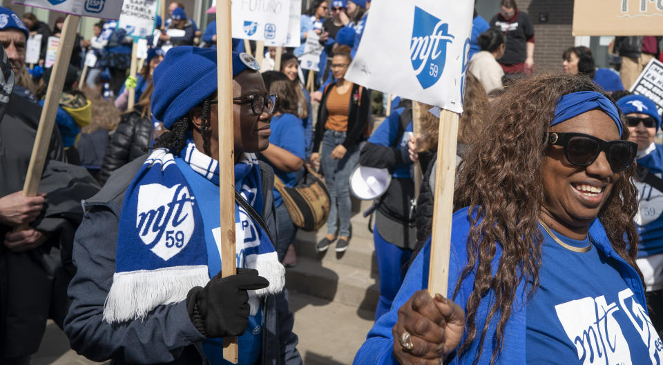 Minneapolis teachers walk the picket line on the 10th day of the teachers strike in front of the Davis Center in Minneapolis, Monday, March 21, 2022. (Jerry Holt/Star Tribune via AP)