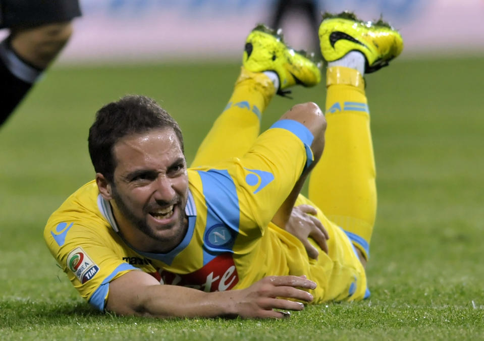 Napoli's Gonzalo Higuain of Argentina falls on the pitch during a Serie A soccer match against Parma, at Parma's Tardini stadium, Italy, Sunday, April 6, 2014. (AP Photo/Marco Vasini)