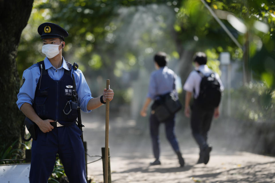 A police officer stands guard near where the state funeral of former Prime Minister Shinzo Abe is to be held as authorities have deployed extra officers to beef up securities in Tokyo, Monday, Sept. 26, 2022. Japanese Prime Minister Fumio Kishida is hosting the controversial state-sponsored ceremony for the former leader Tuesday. (AP Photo/Hiro Komae)