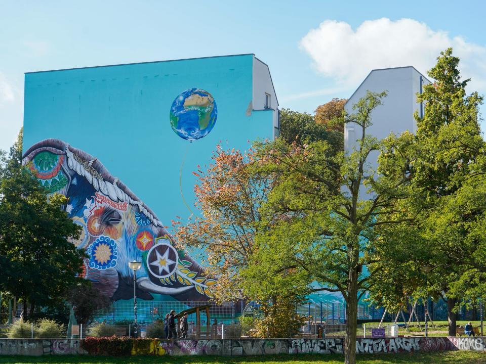 A mural on a building overlooking a park in Berlin.