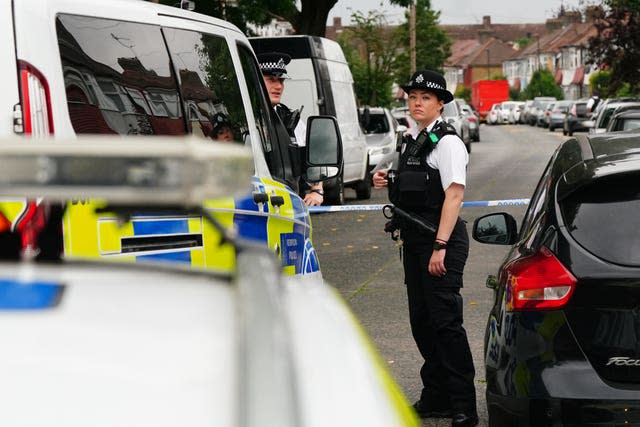 Police officers at the scene of the fatal stabbing