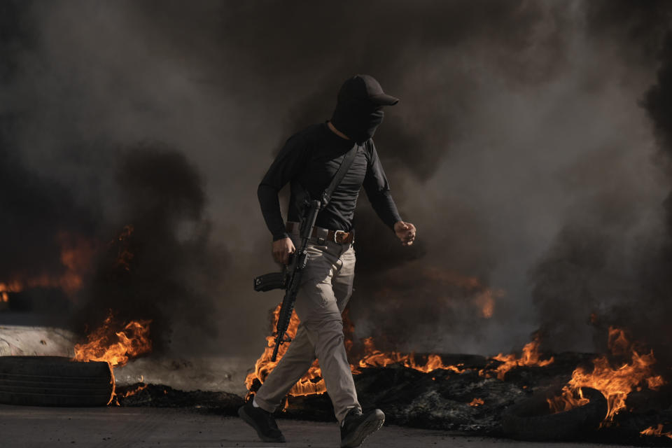 Palestinian military runs during clashes with Israeli forces in Jenin refugee camp in the West Bank, Thursday, Nov. 9, 2023l. (AP Photo/Majdi Mohammed)