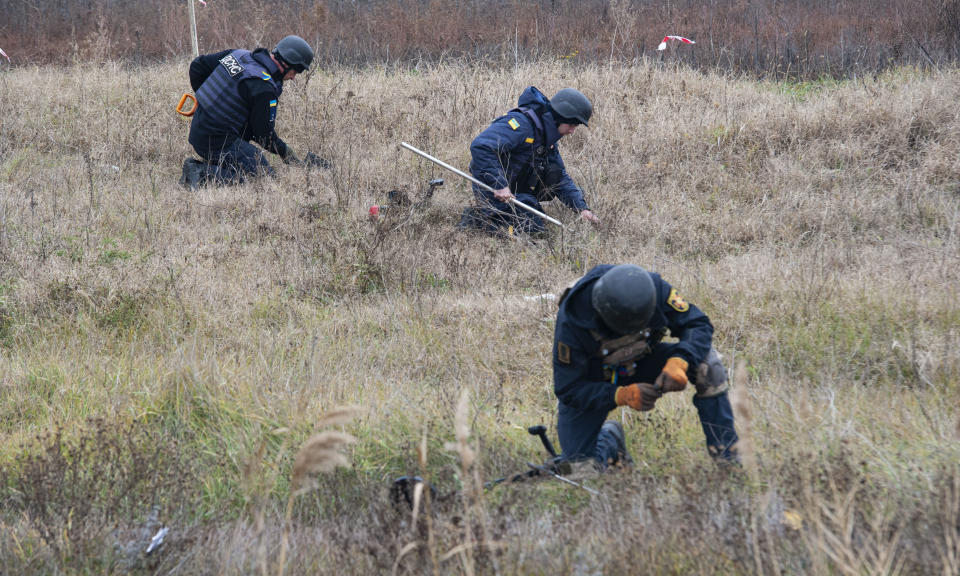 Ukrainian deminers working to clear fields outside the city of Kherson of mines and unexploded ordnance. (Danylo Antoniuk for Yahoo News)