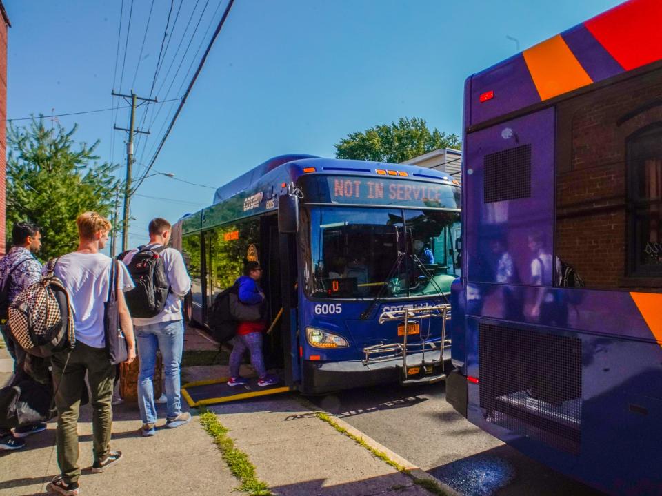 Amtrak passengers board a bus in New York in August 2022.