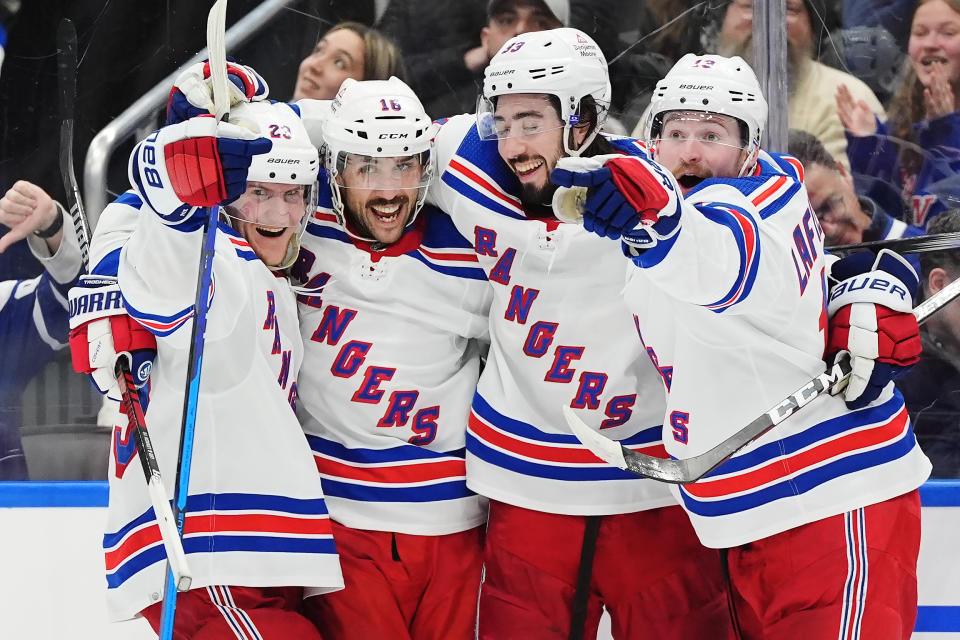 New York Rangers' Vincent Trocheck (16) celebrates his goal against the Toronto Maple Leafs with Adam Fox, left to right, Mika Zibanejad and Alexis Lafreniere during the third period of an NHL hockey game in Toronto on Saturday, March 2, 2024. (Frank Gunn/The Canadian Press via AP)