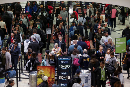 FILE PHOTO: Long lines are seen at a Transportation Security Administration (TSA) security checkpoint at Hartsfield-Jackson Atlanta International Airport amid the partial federal government shutdown, in Atlanta, Georgia, U.S., January 18, 2019. REUTERS/Elijah Nouvelage