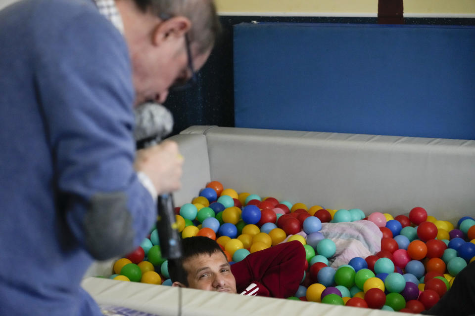 Riccardo Mure', right, and Danilo Petronelli enjoy their day inside the Chicco community of L'Arche, an International charity that helps people with intellectual disabilities, in Ciampino, near Rome, Wednesday, March 22, 2023. The findings of expert reports commissioned by L’Arche itself reveal that their founder, Jean Vanier, perverted Catholic doctrine to justify his own sexual compulsions and abuse women and that the movement he created had at its core a secret, a mystical-sexual “sect” founded for the precise purpose of hiding the sect’s deviant activities from church authorities. (AP Photo/Gregorio Borgia)