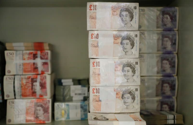 Wads of British Pound Sterling banknotes are stacked in piles at the Money Service Austria company's headquarters in Vienna