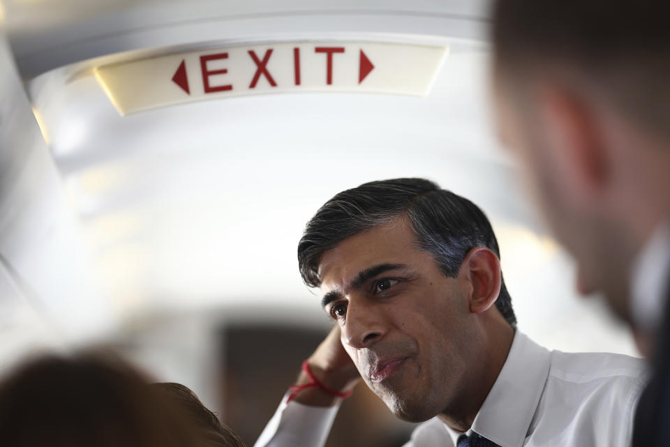 FILE - British Prime Minister Rishi Sunak talks to journalists on his plane as he travels from Northern Ireland to Birmingham during a day of campaigning for this year's General Election due to be held on July 4, on Friday May 24, 2024. (Henry Nicholls/Pool Photo via AP, File)