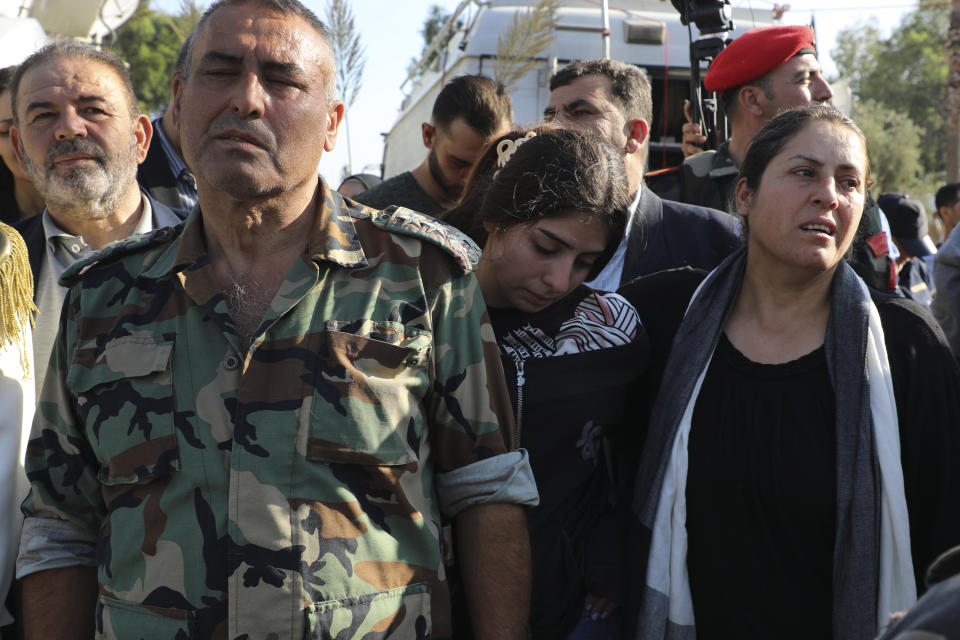 Relatives of the victims who were killed on Thursday in a drone attack that hit a military graduation ceremony, mourn during a mass funeral procession in Homs, Syria, Friday, Oct. 6, 2023. Family members of some of the victims of deadly drone attacks on a crowded military graduation that killed scores gathered outside a military hospital in this central city Friday to collect the bodies of their loved ones who lost their lives in one of Syria's deadliest single attacks in years. (AP Photo/Abdelrahman Shaheen)