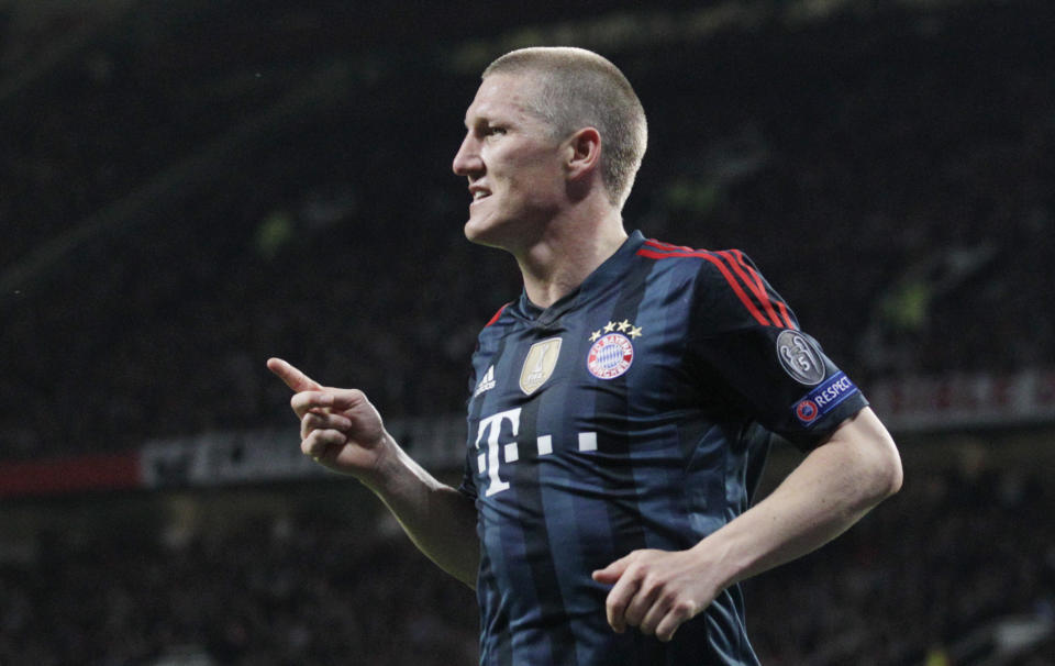 Bayern's Bastian Schweinsteiger celebrates scoring his side's first goal during the Champions League quarterfinal first leg soccer match between Manchester United and Bayern Munich at Old Trafford Stadium, Manchester, England, Tuesday, April 1, 2014.(AP Photo/Jon Super)