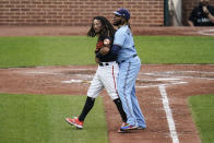 Baltimore Orioles' Freddy Galvis, left, is restrained by Toronto Blue Jays first base Vladimir Guerrero Jr. during a benches-clearing argument in the fourth inning of a baseball game, Saturday, June 19, 2021, in Baltimore. The incident happened as a result of Blue Jays' starting pitcher Alek Manoah hitting Orioles' Maikel Franco with a pitch after Manoah gave up back-to-back home runs to Ryan Mountcastle and DJ Stewart. (AP Photo/Julio Cortez)