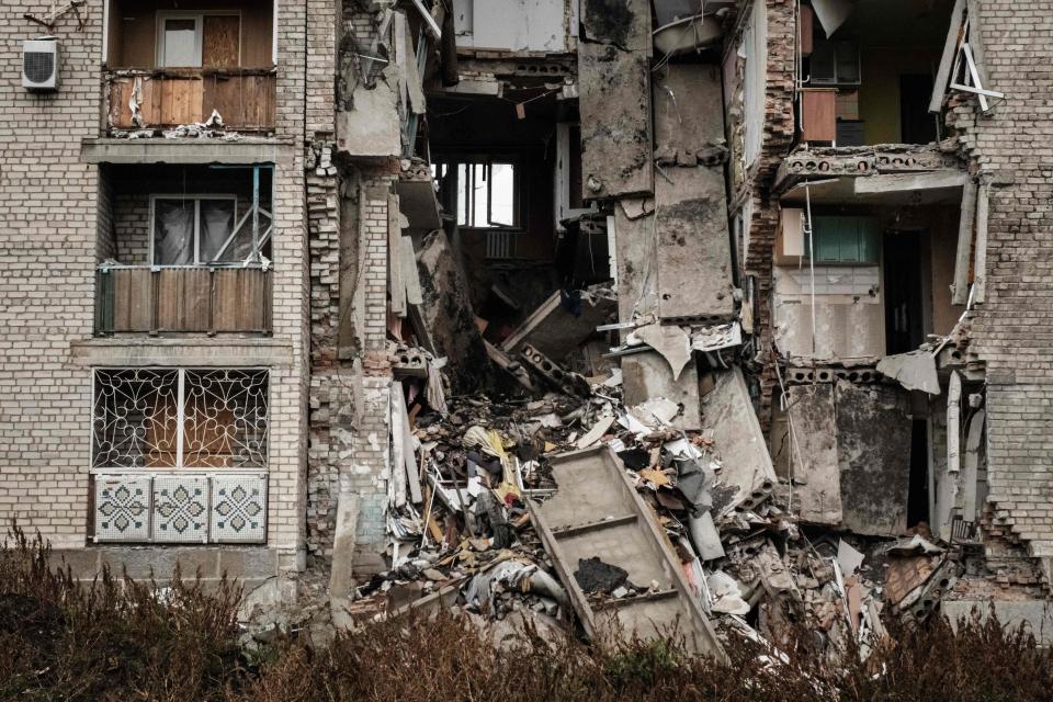 A destroyed apartment remains in the frontline town of Bakhmut in the Donetsk region on October 11, 2022, amid the Russian invasion of Ukraine. - This week's Russian missile attacks on power plants threaten cities across Ukraine with blackouts, but many frontline communities have been under shellfire and without power or water for months. The wine-making and salt-mining down of Bakhmut, in the eastern region of Donetsk, is still held and grimly defended by Ukrainian forces, but its desperate residents have been within range of Russian guns since May. (Photo by Yasuyoshi CHIBA / AFP) (Photo by YASUYOSHI CHIBA/AFP via Getty Images) ORIG FILE ID: AFP_32L76NN.jpg