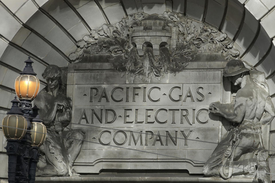 FILE - In this Oct. 10, 2019, file photo, a Pacific Gas and Electric sign sits in the exterior of a PG&E building in San Francisco. California power regulators are weighing a recommendation to back off plans to fine PG&E an additional $462 million for igniting a series of Northern California 2018 deadly wildfires rather than risk that the harsher punishment will scuttle the utility's plan to emerge from bankruptcy protection. The state's Public Utilities Commission is mulling whether to pare the penalties PG&E faces as the result of a proposed revision floated by one of agency's five commissioners, Clifford Rechtschaffen. The document was made public Monday, March 30, 2020. (AP Photo/Jeff Chiu, File)