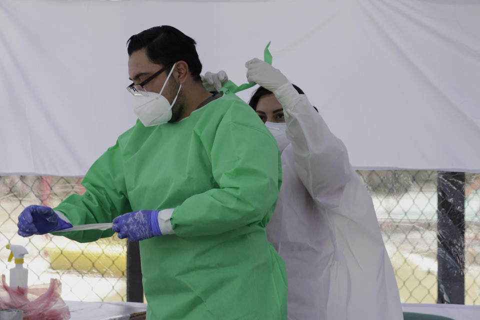 Medical personnel carry out disinfection protocol and equipment removal after carrying out tests for possible detection of possible COVID-19 in Lomas de San Lorenzo, Iztpalapa, on July 15, 2020, one of the neighborhoods in Mexico City that returned to a lockdown due to the high number of infections by coronavirus in the capital. (Photo by Gerardo Vieyra/NurPhoto via Getty Images)