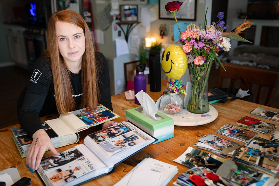 Kuri Bolger looks though photos of her family at her home near Kansas City, Tuesday, Feb. 28, 2023. 