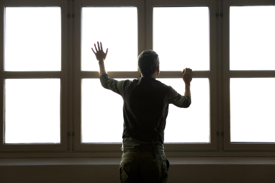 man next to windows