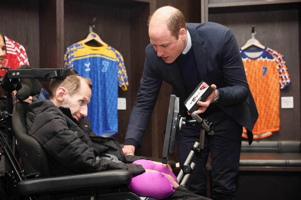 <p>PHIL NOBLE/POOL/AFP via Getty Images</p> Prince William gives Rob Burrow his CBE during the visit in January 2024