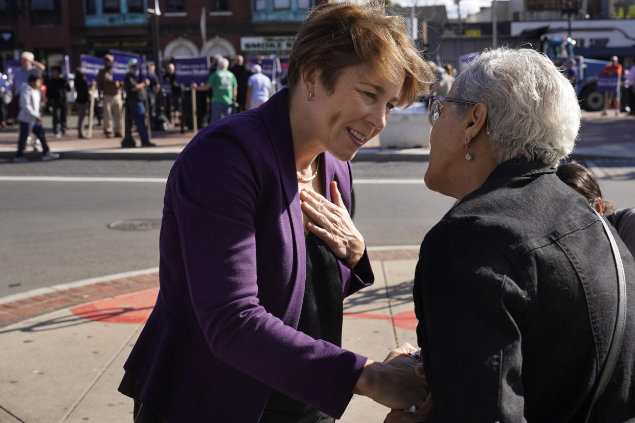 Massachusetts Attorney General and Democratic candidate for Gov. Maura Healey, left, greets Carmen De La Cruz, of Boston, right, during a campaign stop, Monday, Nov. 7, 2022, in Boston's East Boston neighborhood. (AP Photo/Steven Senne)