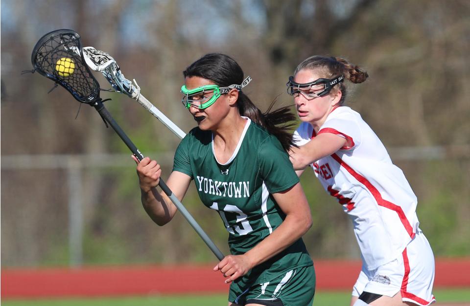 YorktownÕs Lily Diaz (13) drives to the goal in front of Somers Sydney Ingraham (4) during girls lacrosse action at Somers High School April 25, 2024. Yorktown won the game 8-5.