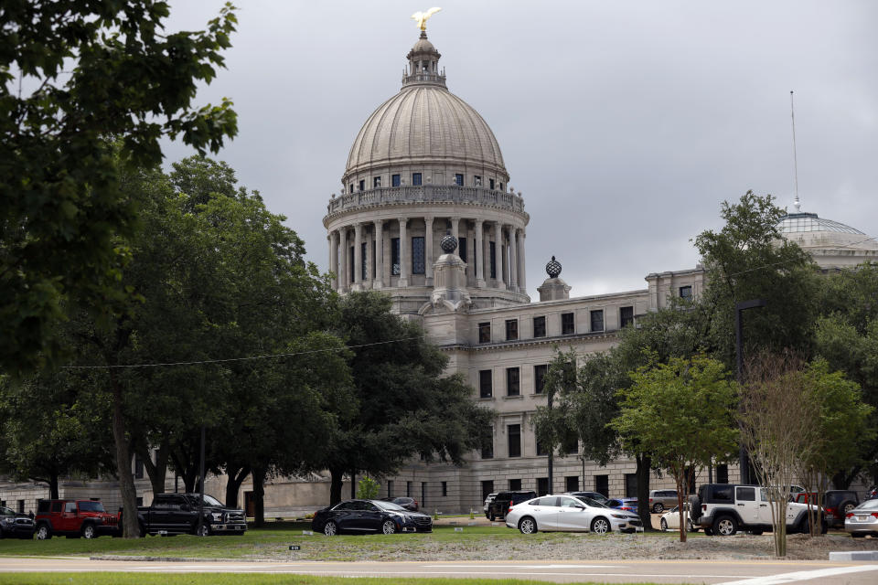 Mississippi legislators, staff and Capitol employees take advantage of a drive-thru COVID-19 testing center on the Capitol grounds in Jackson, Miss., Monday, July 6, 2020, following an incidence at the Mississippi Legislature. House Speaker Philip Gunn confirmed Sunday that he had recently tested positive for COVID-19. (AP Photo/Rogelio V. Solis)