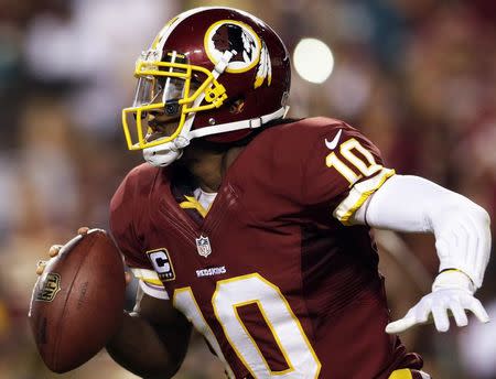 Washington Redskins quarterback Robert Griffin III scrambles against the Philadelphia Eagles' defense during the second half of their NFL football game in Landover, Maryland in this file photo from September 9, 2013. REUTERS/Gary Cameron/Files