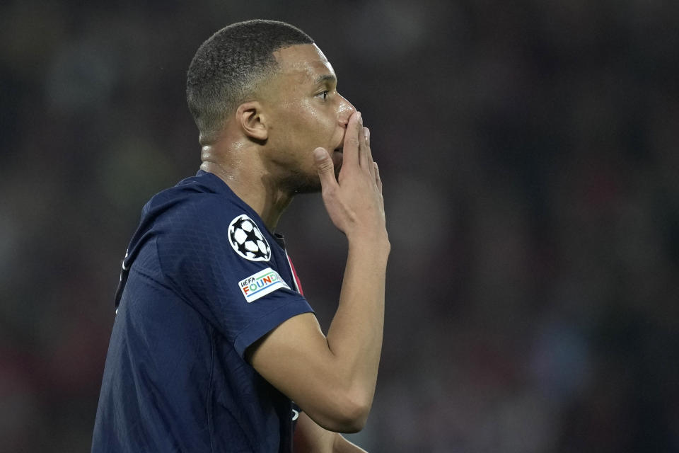 PSG's Kylian Mbappe touches his nose during the Champions League semifinal second leg soccer match between Paris Saint-Germain and Borussia Dortmund at the Parc des Princes stadium in Paris, France, Tuesday, May 7, 2024. (AP Photo/Christophe Ena)