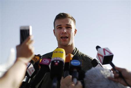 Royal Australian Air Force (RAAF) AP-3C Orion pilot Russell Adams speaks to the press upon his return from a search for Malaysian Airlines flight MH370 over the Indian Ocean, at RAAF Base Pearce north of Perth, Australia, March 21, 2014. REUTERS/Jason Reed