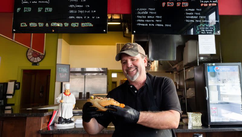 Vito Leone, owner of Vito’s, poses for a portrait holding a Philly cheesesteak at Vito’s in Bountiful on Monday, Jan. 8, 2024. Vito’s is a cash-only eatery specializing in Philly cheesesteaks.