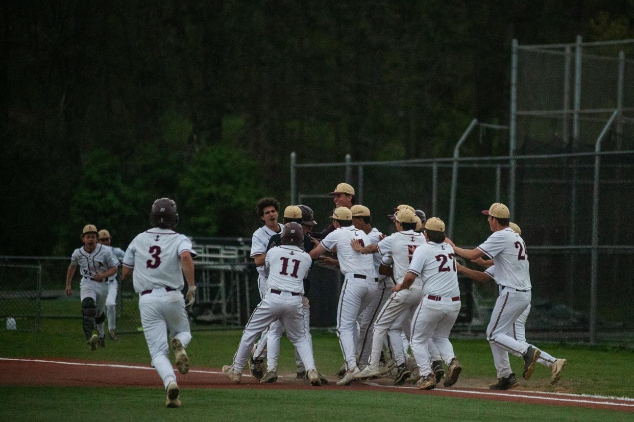 The Arlington baseball team celebrates its walkoff win over John Jay in an April 30, 2024 game at Arlington High School.