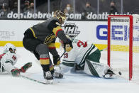 Vegas Golden Knights left wing Max Pacioretty (67) scores against Minnesota Wild goaltender Cam Talbot (33) during overtime of an NHL hockey game Monday, March 1, 2021, in Las Vegas. (AP Photo/John Locher)