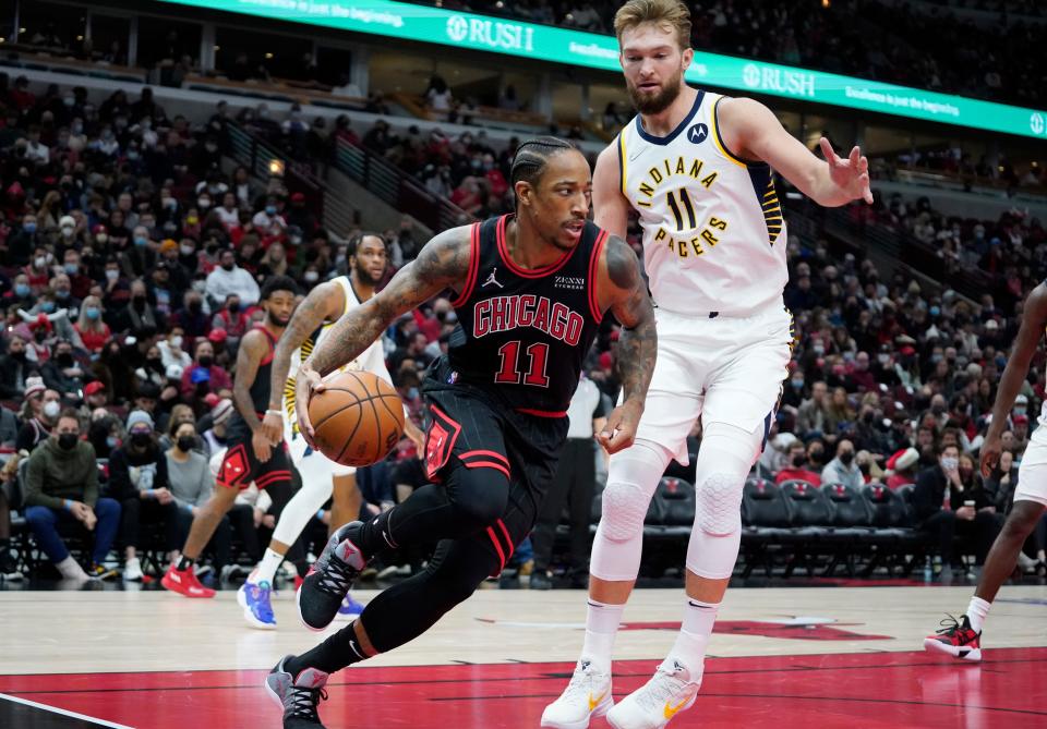 Dec 26, 2021; Chicago, Illinois, USA; Indiana Pacers forward Domantas Sabonis (11) defends Chicago Bulls forward DeMar DeRozan (11) during the first half at United Center. Mandatory Credit: David Banks-USA TODAY Sports