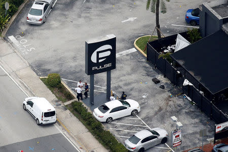 FILE PHOTO: Investigators work the scene following a mass shooting at the Pulse gay nightclub in Orlando Florida, U.S. on June 12, 2016. REUTERS/Carlo Allegri/File Photo