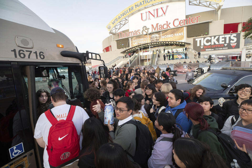 University of Nevada, Las Vegas, students, faculty and staff board public buses to get off campus after a fatal shooting on Wednesday, Dec. 6, 2023, in Las Vegas. Many students, faculty and staff, were trapped on campus as roads were shut down and dorms were closed. (Steve Marcus/Las Vegas Sun via AP)