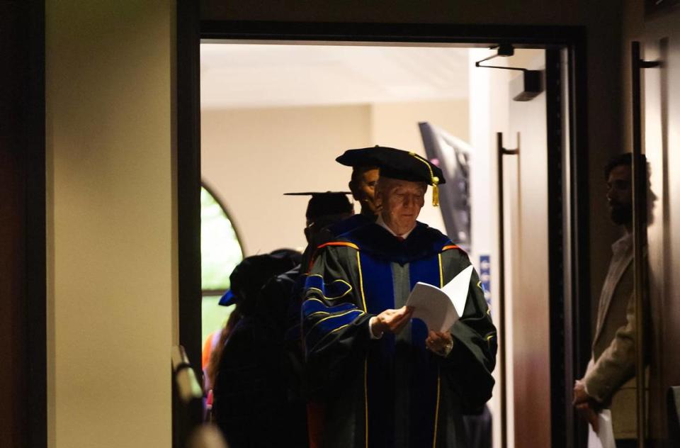 David Dockery, president of Southwestern Baptist Theological Seminary, glances at his notes before leading the procession during graduation on Friday, May 5, 2023, in Fort Worth.