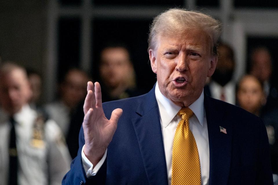 Donald Trump outside the courtroom on 14 May (EPA)