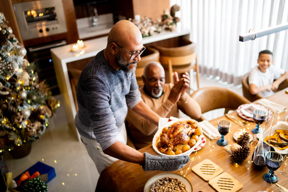 Mature man serving roast turkey on Christmas day at home