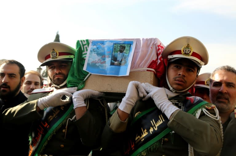 The Iranian honour guard carries the coffin of Iran's former ambassador to Lebanon Ghazanfar Roknabadi, who was killed in Saudi Arabia, during a repatriation ceremony at Tehran's Mehrabad Airport on November 27, 2015