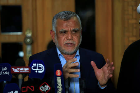 FILE PHOTO: Leader of the Conquest Coalition and the Iran-backed Shi'ite militia Badr Organisation Hadi al-Amiri speaks during a news conference with Iraqi Shi'ite cleric Moqtada al-Sadr (not pictured), in Najaf, Iraq June 12, 2018. REUTERS/Alaa al-Marjani