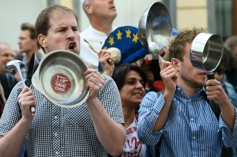 Activists bang on pans during a protest against the Transatlantic Trade and Investment Partnership (TTIP) in front of the EU commission building in Brussels, in July 2016