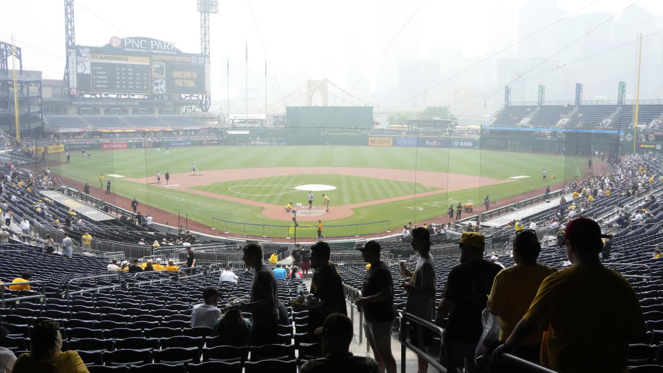 Haze from Canadian wildfires hangs over downtown Pittsburgh and PNC Park as fans take their seats before a baseball game between the Pittsburgh Pirates and the San Diego Padres in Pittsburgh, Thursday, June 29, 2023. (AP Photo/Gene J. Puskar)