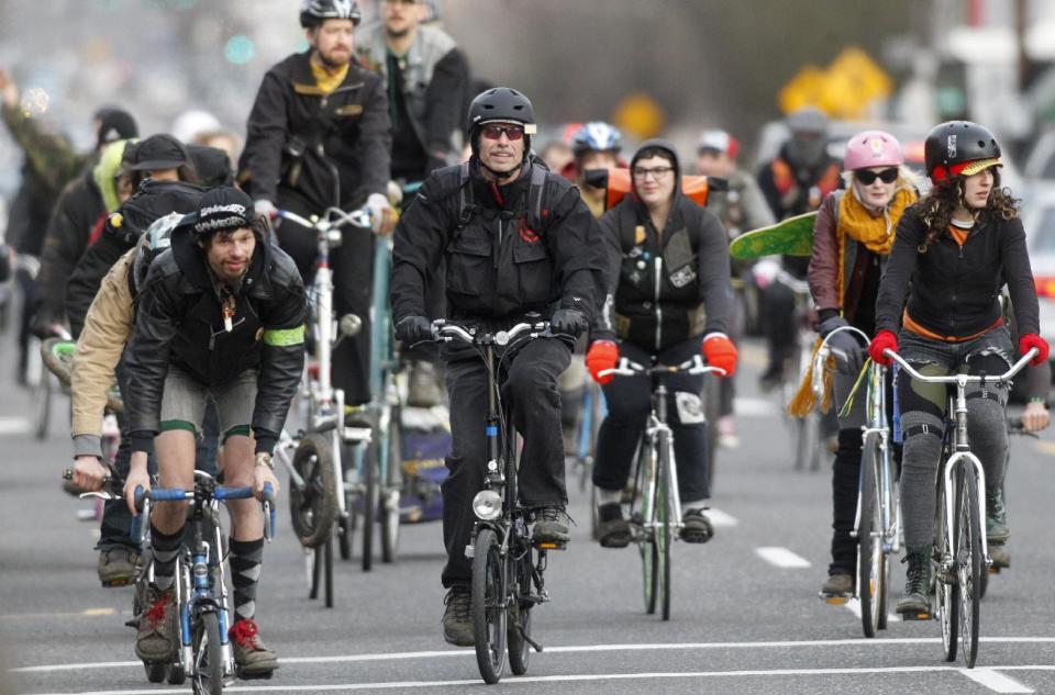 Riders travel along a Portland, Ore., street during the Mini Bike Winter Olympics Sunday, Feb.19, 2012. Oregon’s largest city has an obsession with bikes. (AP Photo/Rick Bowmer)