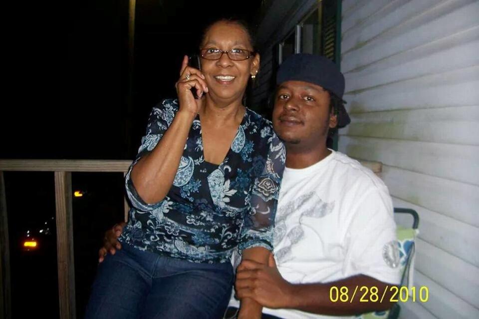 In this 2010 photograph, Patricia Tatum, left, sits on the lap of her son, Derrick Williams, right, during Tatum’s 60th birthday celebration. Williams has been stuck in the Clay County Detention Center waiting to be transferred to a mental health facility. 