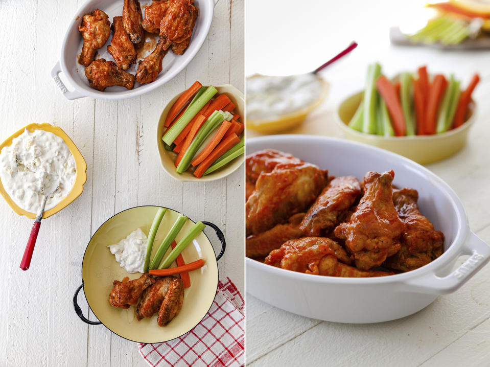 This combination of images shows a recipe for air fryer buffalo chicken wings with blue cheese dip and carrot and celery sticks. (Carrie Crow via AP)