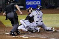 Arizona Diamondbacks Pavin Smith is tagged out at the plate by Colorado Rockies catcher Elias Diaz during the fifth inning of a baseball game, Saturday, Sept. 26, 2020, in Phoenix. Smith was trying to score on a base hit by Jon Jay. (AP Photo/Matt York)