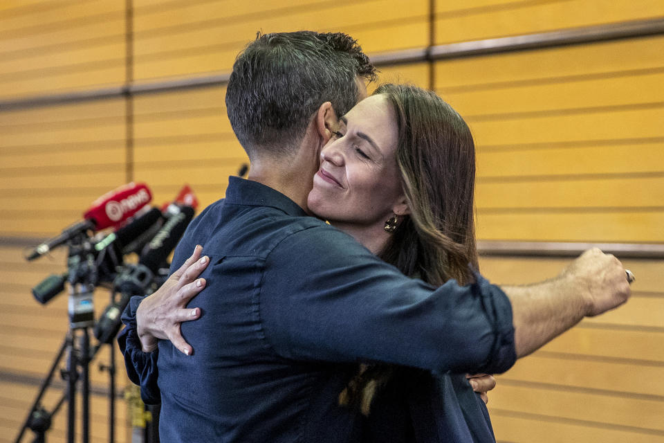 New Zealand Prime Minister Jacinda Ardern, right, hugs her fiancee Clark Gayford after announcing her resignation at a press conference in Napier, New Zealand, Thursday, Jan. 19, 2023. Fighting back tears, Ardern told reporters that Feb. 7 will be her last day in office. (Mark MItchell/New Zealand Herald via AP)