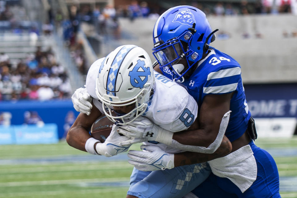 Georgia State safety Antavious Lane tackles North Carolina wide receiver Kobe Paysour in the second half of an NCAA college football game Saturday, Sept. 10, 2022, in Atlanta. (AP Photo/Hakim Wright Sr.)